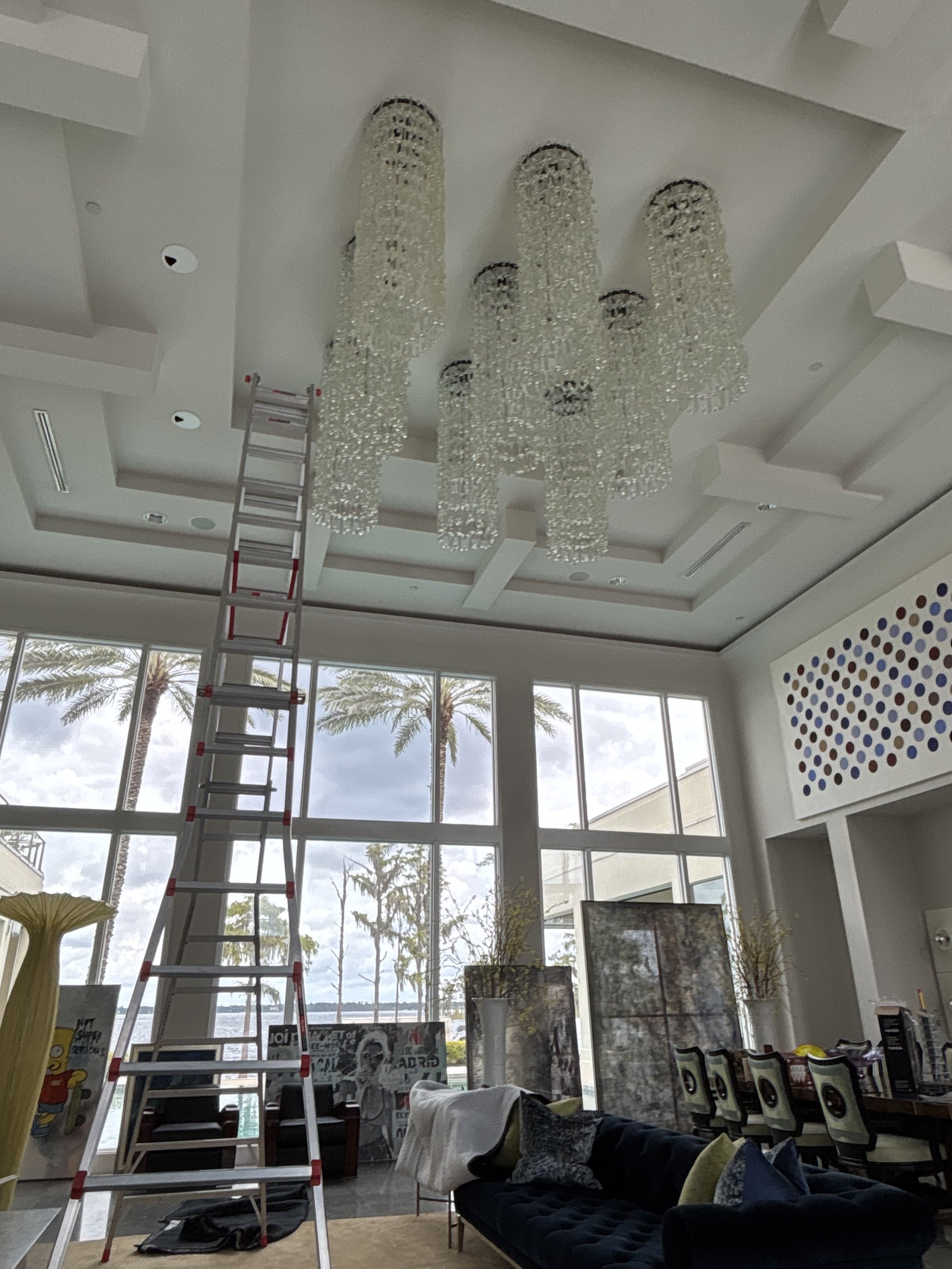 All nine handblown glass chain-link chandeliers with 17-foot ladder in position