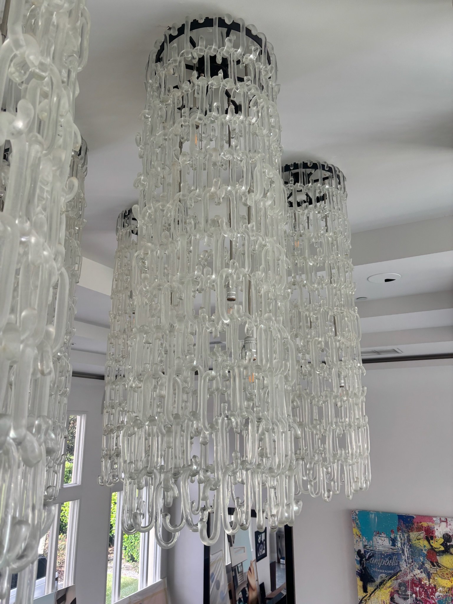 Single handblown glass chain-link chandelier showing hundreds of interlocking glass links