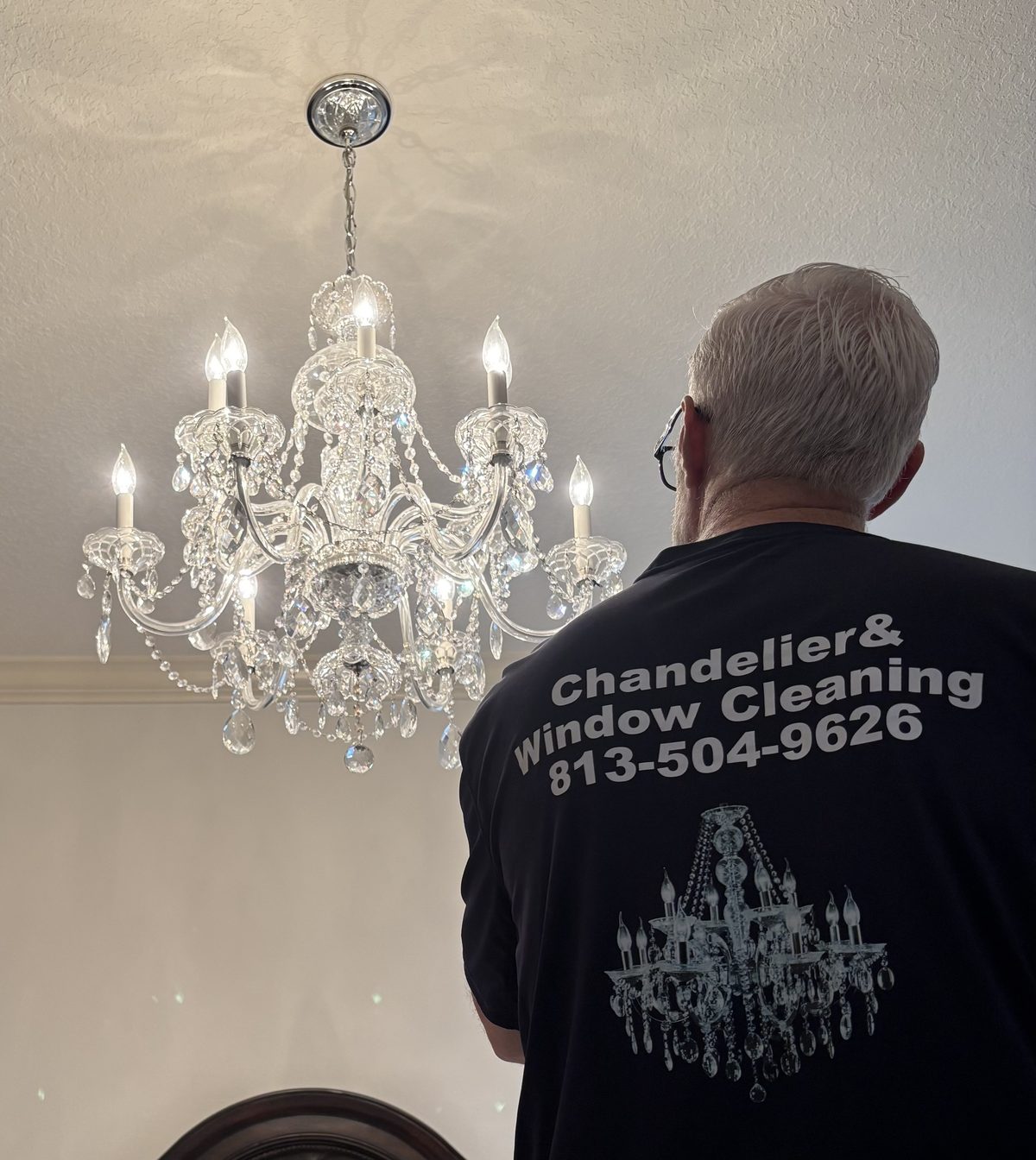 Hand cleaning a crystal chandelier