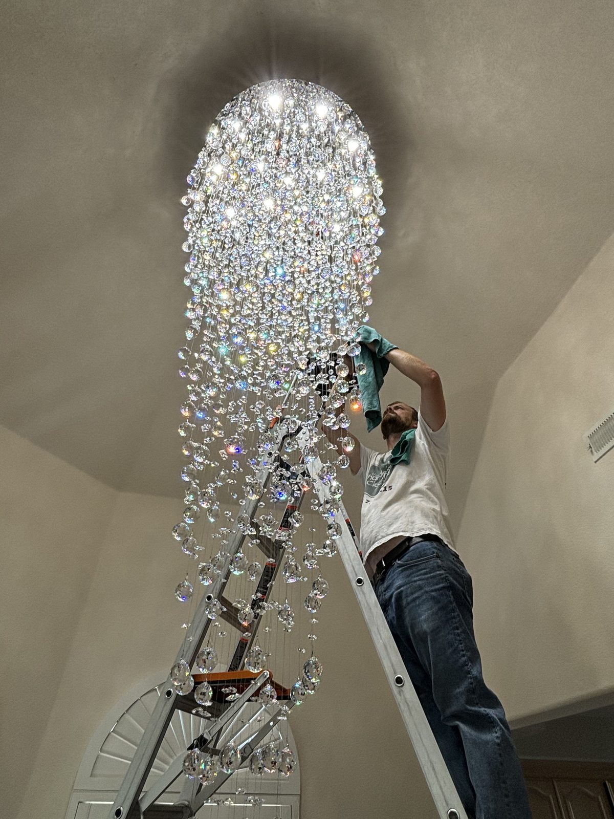 Raindrop cascade chandelier being cleaned