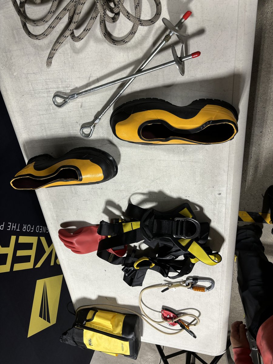Tucker fall protection gear display: harness, anchor shoes, and safety line