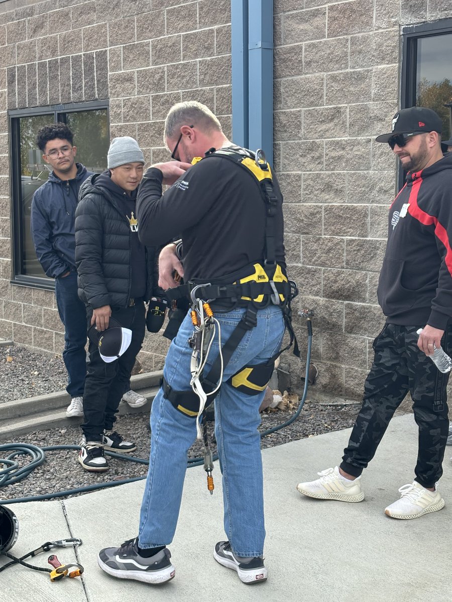 Hands-on harness fitting during outdoor safety training